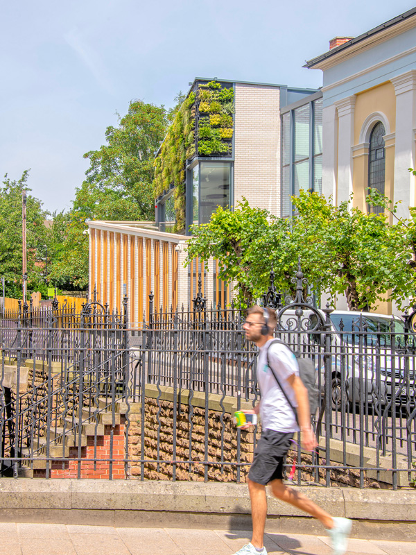 Student walking past building