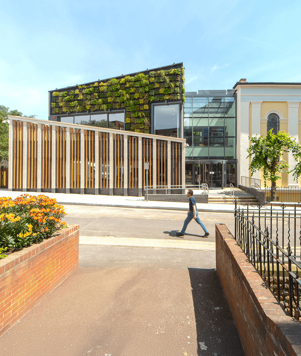 Man walking in front of building