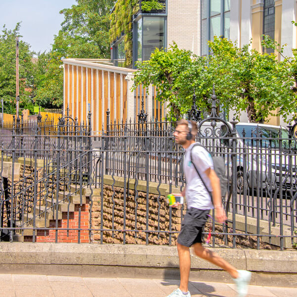 Man walking past a building